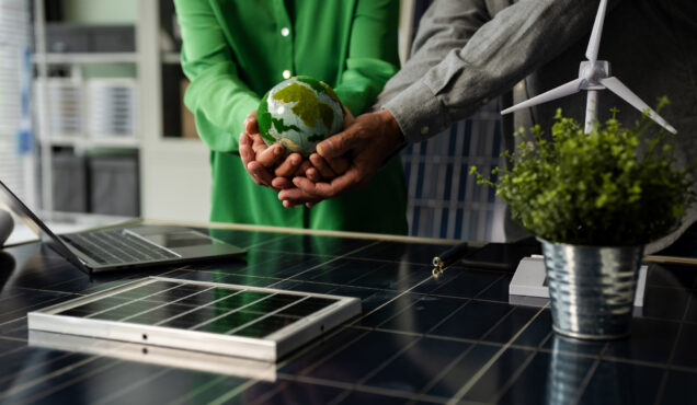 Two colleagues discussing data working and tablet, laptop with on Construction Site project, green energy and solar panel concept.
